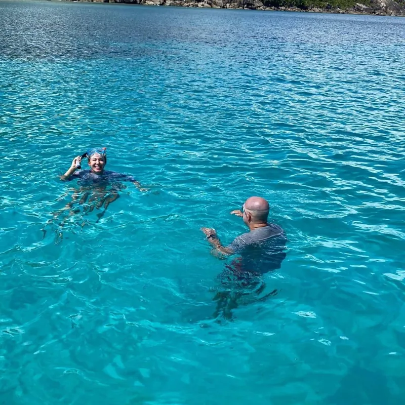 A crystal-clear glass-bottom kayak revealing colorful coral reef life at Sainte Anne Marine National Park on a seychelles boat tour from Mahé